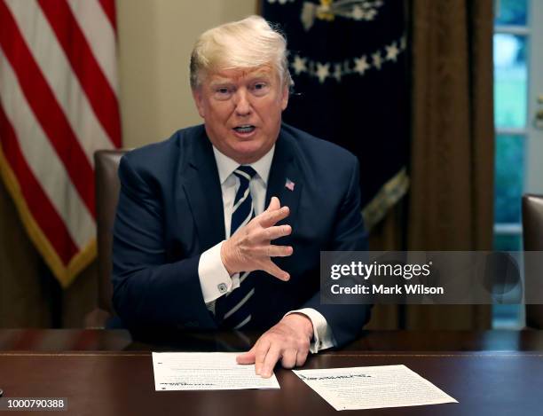 President Donald Trump talks about his meeting with Russian President Vladimir Putin, during a meeting with House Republicans in the Cabinet Room of...