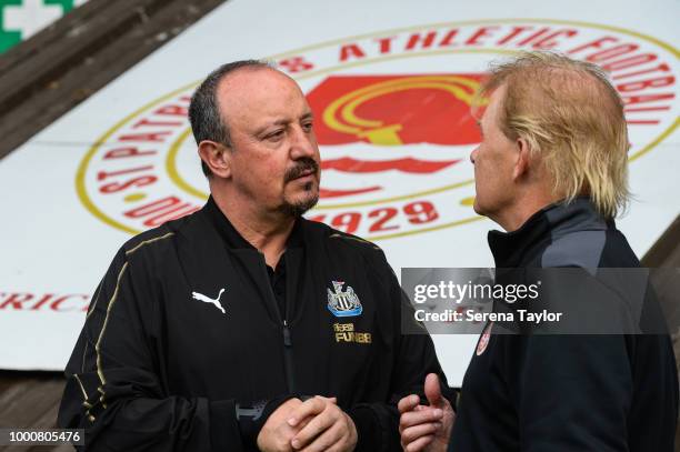 Newcastle United Manager Rafael Benitez speaks to St.Patrick Athletic Manager Liam Buckley before the Pre Season Friendly match between St.Patricks...