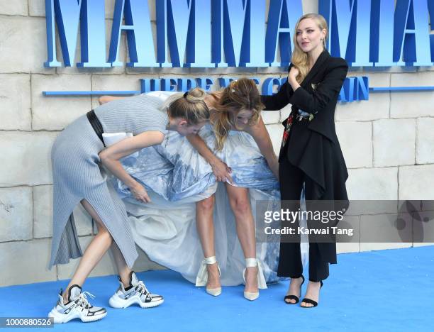 Lily James and Amanda Seyfried attend the World Premiere of "Mamma Mia! Here We Go Again" at Eventim Apollo on July 16, 2018 in London, England.