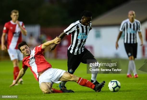 Christian Atsu of Newcastle United runs with the ball whilst being tackled by Lee Desmond of St.Patricks Athletic F.C. During the Pre Season Friendly...