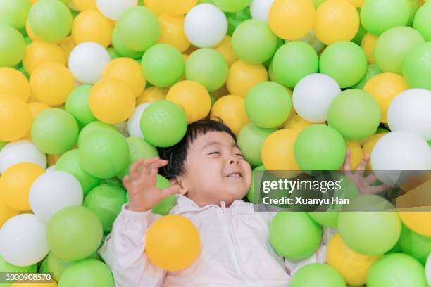 lovely little girl playing joyfully in ball pit - who could play young han solo stock pictures, royalty-free photos & images