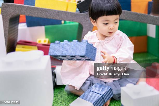 lovely little girl playing with plastic blocks - who could play young han solo stock pictures, royalty-free photos & images