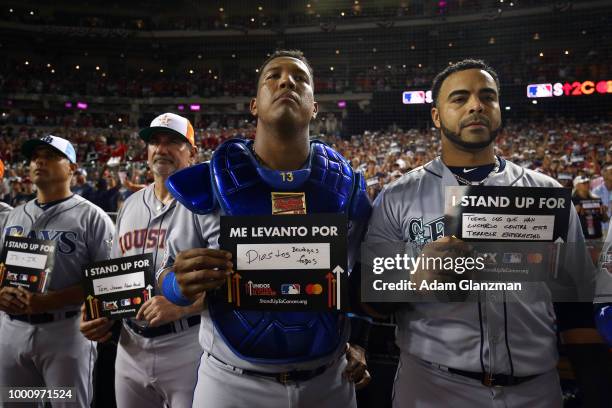 Salvador Perez of the Kansas City Royals and Nelson Cruz of the Seattle Mariners hold up Stand Up to Cancer placards during the 89th MLB All-Star...