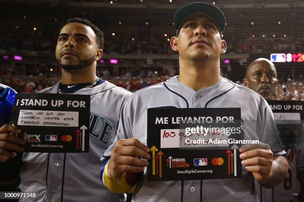 Nelson Cruz of the Seattle Mariners and Wilson Ramos of the Tampa Bay Rays hold up Stand Up to Cancer placards during the 89th MLB All-Star Game at...