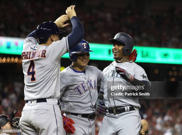 George Springer of the Houston Astros and the American League and Shin-Soo Choo of the Texas Rangers and the American League celebrate after scoring...