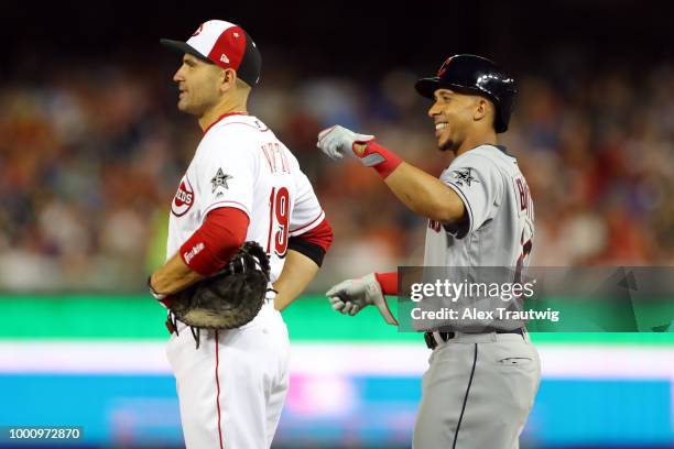 Michael Brantley of the Cleveland Indians jokes with Joey Votto of the Cincinnati Reds at first base during the the 89th MLB All-Star Game at...