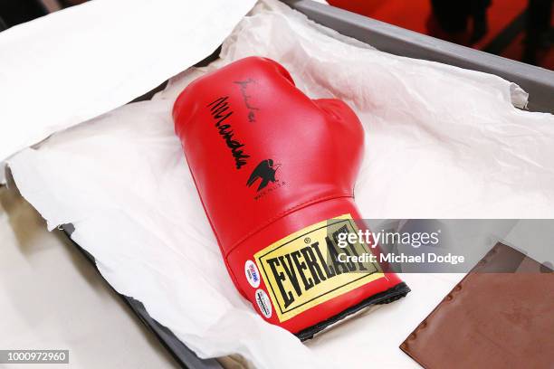 Handlers unveil a boxing glove signed by Nelson Mandela at Melbourne Museum on July 18, 2018 in Melbourne, Australia. Mandela My Life: The Official...