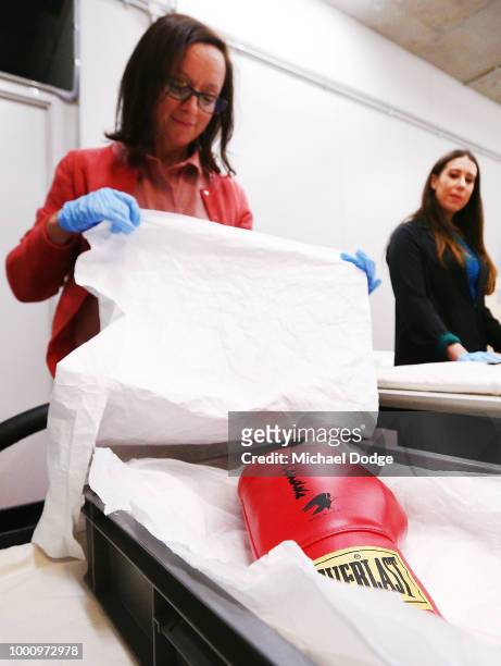 Handlers unveil a boxing glove signed by Nelson Mandela at Melbourne Museum on July 18, 2018 in Melbourne, Australia. Mandela My Life: The Official...
