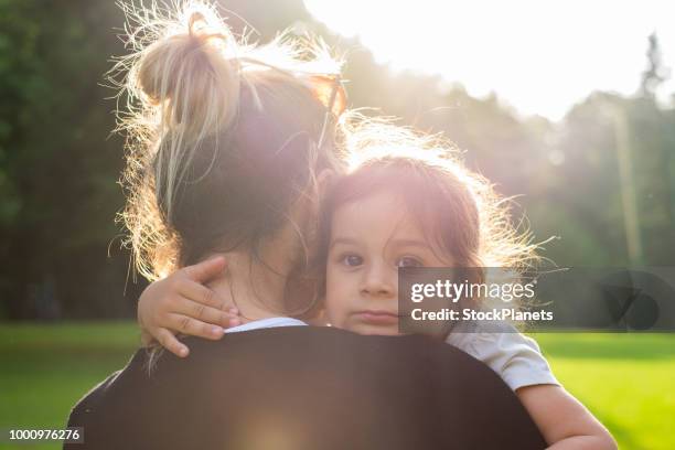 mothers hug - baby girls stock pictures, royalty-free photos & images