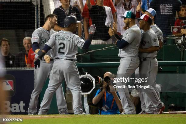 Jean Segura of the Seattle Mariners celebrates with his National League teammates Mitch Haniger of the Seattle Mariners, Nelson Cruz of the Seattle...