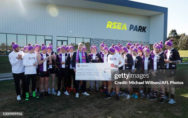 Jarryn Geary of the Saints presents Nick Riewoldt with a cheque for $5,000 from the AFLPA Players Care to Maddie Riewoldt's Vision during an AFL...