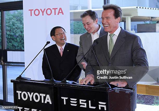 Toyota CEO Akio Toyoda, Tesla Motors CEO Elon Musk and California governor Arnold Schwarzenegger laugh during a news conference at Tesla Motors...