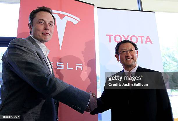 Tesla Motors CEO Elon Musk and Toyota CEO Akio Toyoda shake hands after a news conference at Tesla Motors headquarters May 20, 2010 in Palo Alto,...