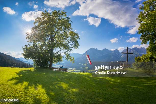 lonely man sitting on bench with view to wilder kaiser, austria, tirol  - kaiser mountains - kitzbuehel stock pictures, royalty-free photos & images