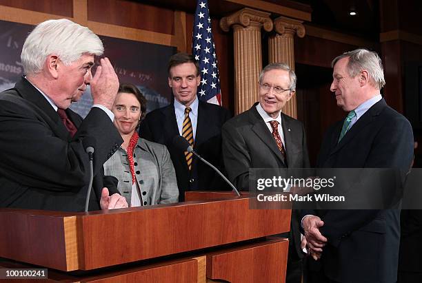 Sen. Christopher Dodd , salutes Senate Majority Leader Harry Reid with Sen. Richard Durbin , Sen. Blanche Lincoln and Sen. Mark Warner , after voting...