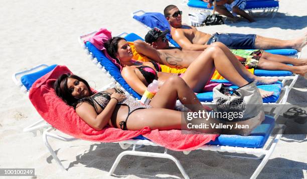 Television personalities Nicole "Snooki" Polizzi, Jenni "JWoww" Farley, Paul "Pauly D" DelVecchio and Vinny Guadagnino visit the beach on May 20,...