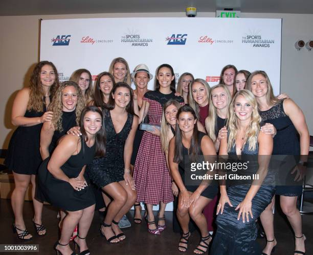 Actress Emmy Rossum poses with the US Womens Hockey Team at the 4th Annual Sports Humanitarian Awards at The Novo by Microsoft on July 17, 2018 in...