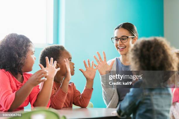 multi-ethnic preschool teacher and students in classroom - counting stock pictures, royalty-free photos & images
