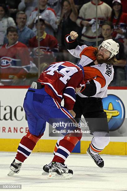 Scott Hartnell of the Philadelphia Flyers fights against Roman Hamrlik of the Montreal Canadiens in Game 3 of the Eastern Conference Finals during...