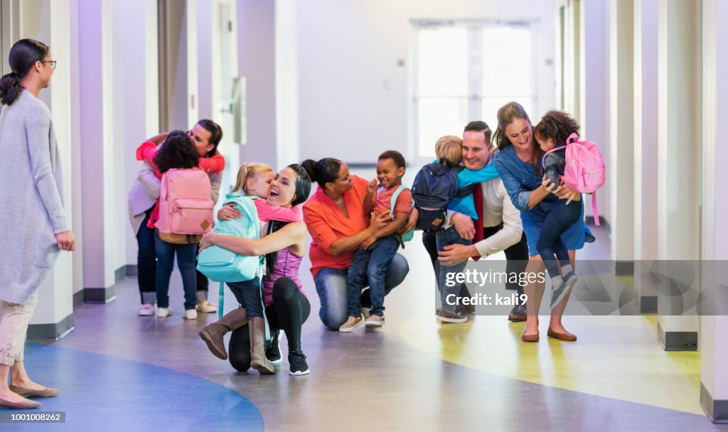 Preschool students, parents, hugs on first day of school