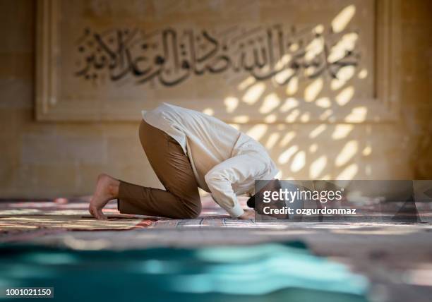 muslimischer mann betet in moschee - islam stock-fotos und bilder