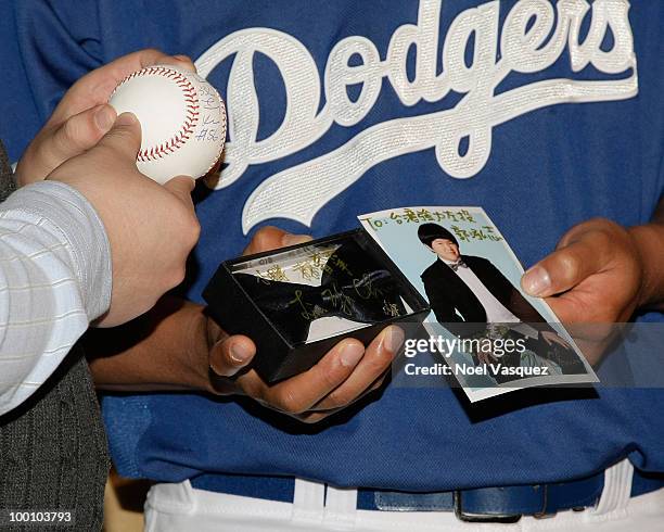 Gifts are exchanged at the Los Angeles Dodger's news conference announcing partnership with Taiwan Tourism Board on May 20, 2010 in Los Angeles,...