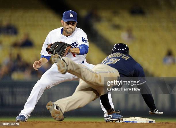 Jamey Carroll of the Los Angeles Dodgers puts the tag on Chris Denorfia of the San Diego Padres at second base as he is picked off first during the...