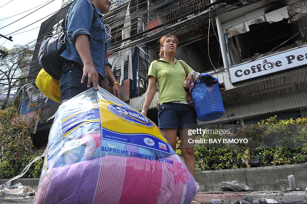 Residents carry their belongings from th