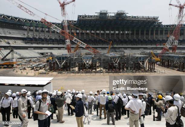 Members of the media tour the construction site of the New National Stadium, the main venue for the Tokyo 2020 Olympic and Paralympic Games, in...