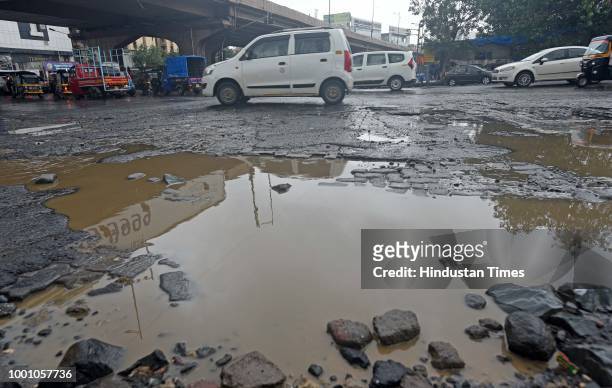 Huge Potholes on WEH at Jogeshwari, on July 17, 2018 in Mumbai, India. The potholed roads in Mumbai and its surrounding areas have led to several...