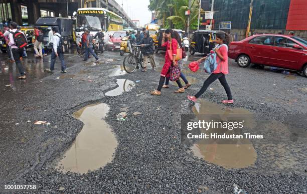 Huge potholes on WEH under Andheri bridge, on July 17, 2018 in Mumbai, India. The potholed roads in Mumbai and its surrounding areas have led to...