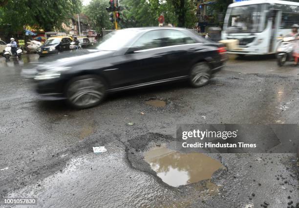 Huge pothole at Arthur Rd Naka at Saat Rastha, on July 17, 2018 in Mumbai, India. The potholed roads in Mumbai and its surrounding areas have led to...