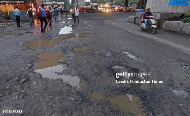 Huge potholes on WEH under Andheri bridge, on July 17, 2018 in Mumbai, India. The potholed roads in Mumbai and its surrounding areas have led to...