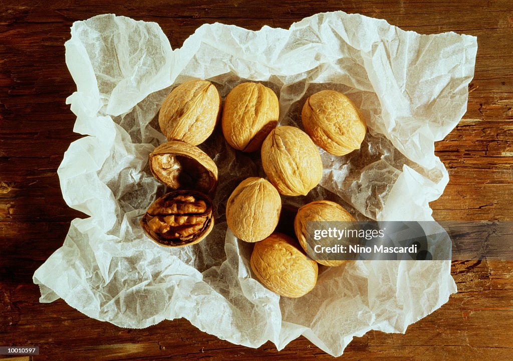 WALNUTS ON WHITE CRUMPLED PAPER