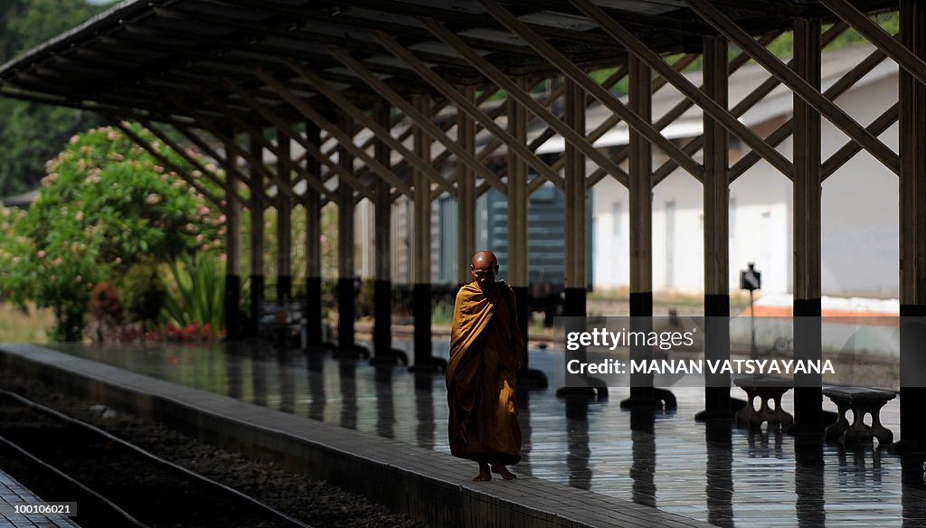 A Buddhist monk walks on the platform be