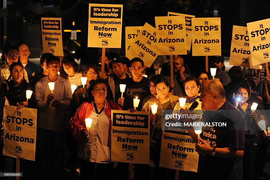 Mexican and Latino janitors hold a candl