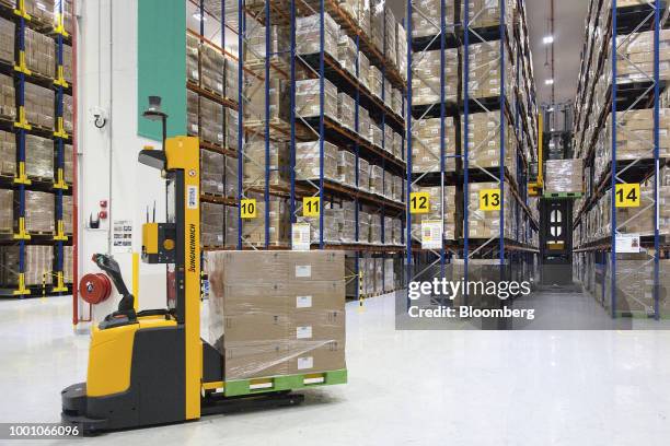 An automated guided vehicle transports boxes inside the Toll City warehousing facility operated by Toll Holdings Ltd, a unit of Japan Post Holdings...