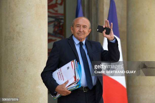 French Interior Minister Gerard Collomb waves as he leaves after a weekly cabinet meeting on July 18, 2018 at the Elysee palace in Paris.