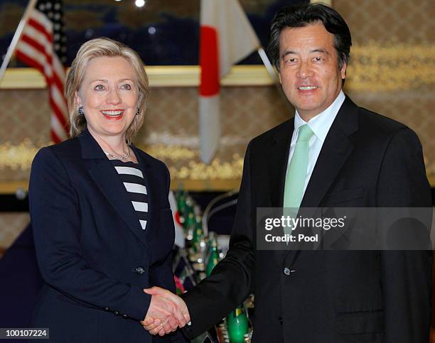 Secretary of State Hillary Clinton shakes hands with her Japanese counterpart Katsuya Okada before their meeting at the Foreign Ministry's Iikura...