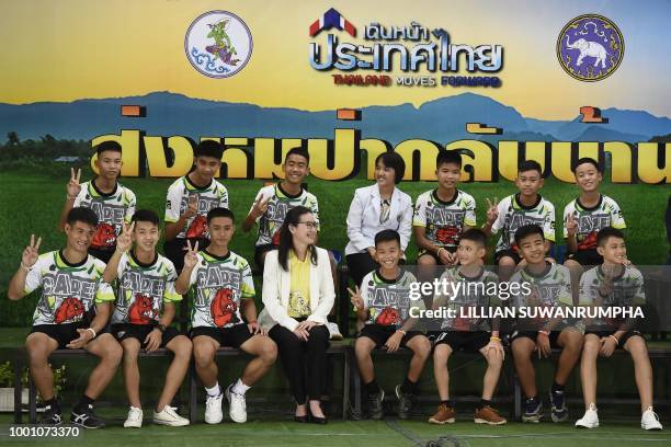 Twelve Thai boys and their football coach, rescued from a flooded cave after being trapped, attend a press conference in Chiang Rai on July 18...