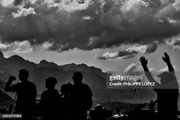 Spectators wait at the start line prior to the tenth stage of the 105th edition of the Tour de France cycling race between Annecy and Le...