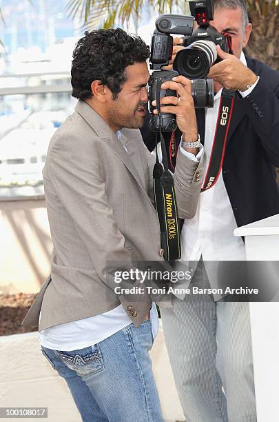 Actor Jamel Debbouze takes a photo as he attends the 'Outside the Law' Photo Call held at the Palais des Festivals during the 63rd Annual...