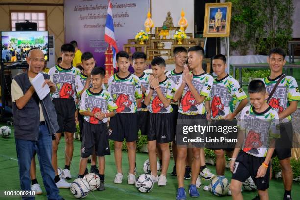 Twelve boys and their coach, Ekkapol Chantawong , from the "Wild Boars" soccer team arrive for a press conference for the first time since they were...