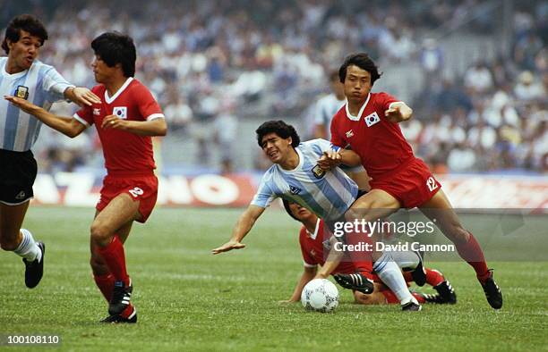 Diego Maradona of Argentina is fouled by players from the Republic of Korea during the Group A match at the 1986 FIFA World Cup on 2 June 1986 at the...