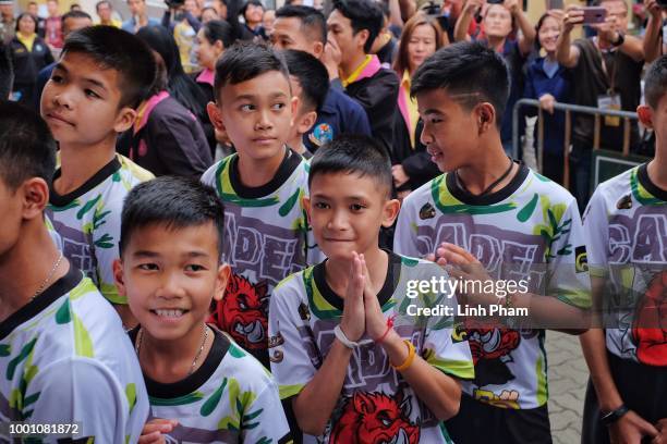 Twelve boys and their coach from the "Wild Boars" soccer team arrive for a press conference for the first time since they were rescued from a cave in...
