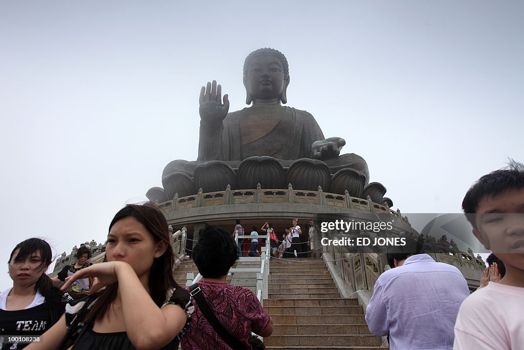 People stand before the Tian Tan Buddha