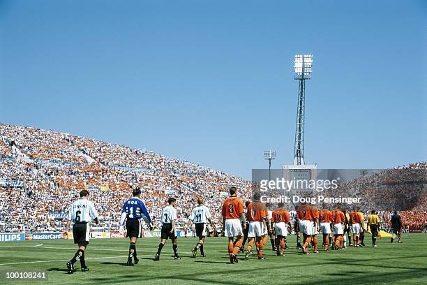 The teams of Argentina and the Netherlands walk onto the field ahead of their 1998 FIFA World Cup Quarter Final match on 4 July 1998 played at the...