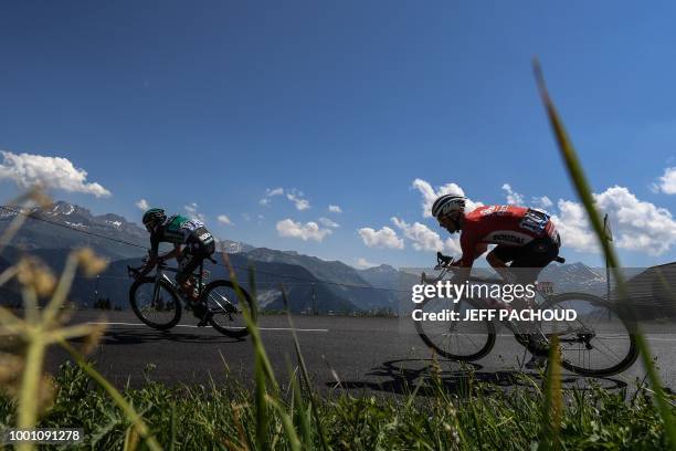 Poland's Pawel Poljanski and Poland's Tomasz Marczynski ride down the Saisies pass following the ascent of Bisanne during the eleventh stage of the...