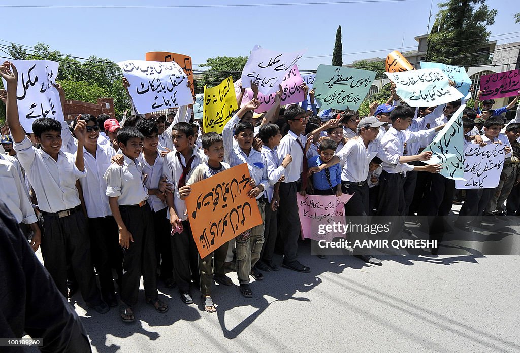 Pakistani students carry placards as the