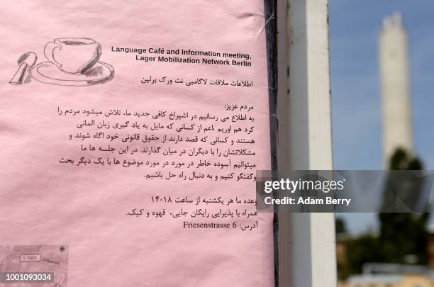 Sign informs residents of meetings at which they can learn their rights as well as take German classes, at a temporary asylum seeker reception center...